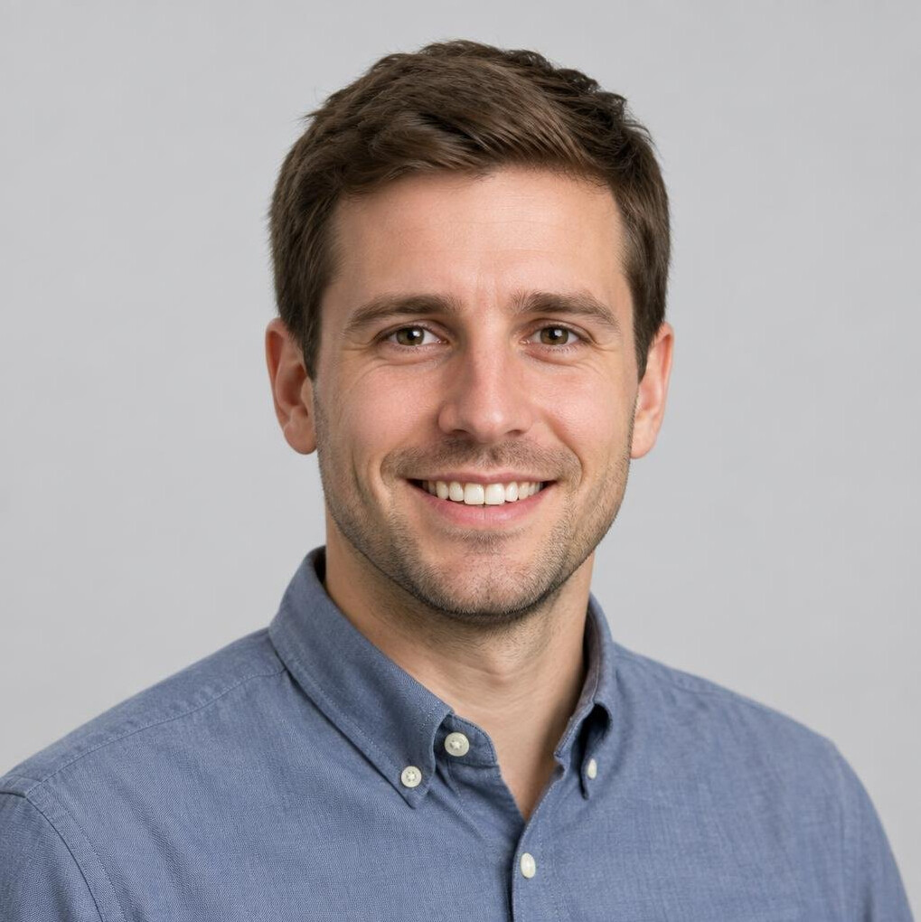 Studio portrait of a Slovenian man in his 30s with short hair smiling